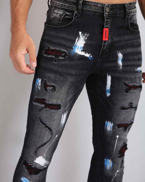 Street Art Chic Ripped Black Jeans with Graffiti Paint Drawing