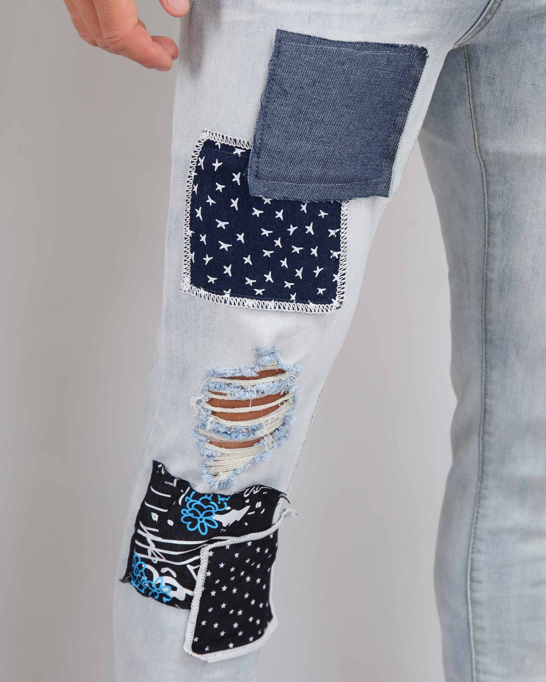 Blue Ripped Jeans with Striking Black Patches