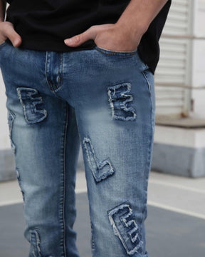 Light Wash Blue Jeans with Ripped Text