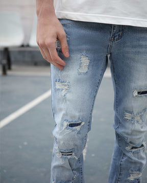 Light Wash Blue Ripped Jeans with Irregular Ripped