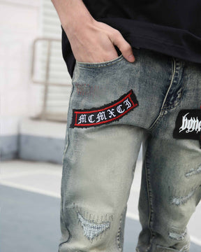 Blue Straight Leg Ripped Jeans with Graphic Print and Personalized Skull Emblem