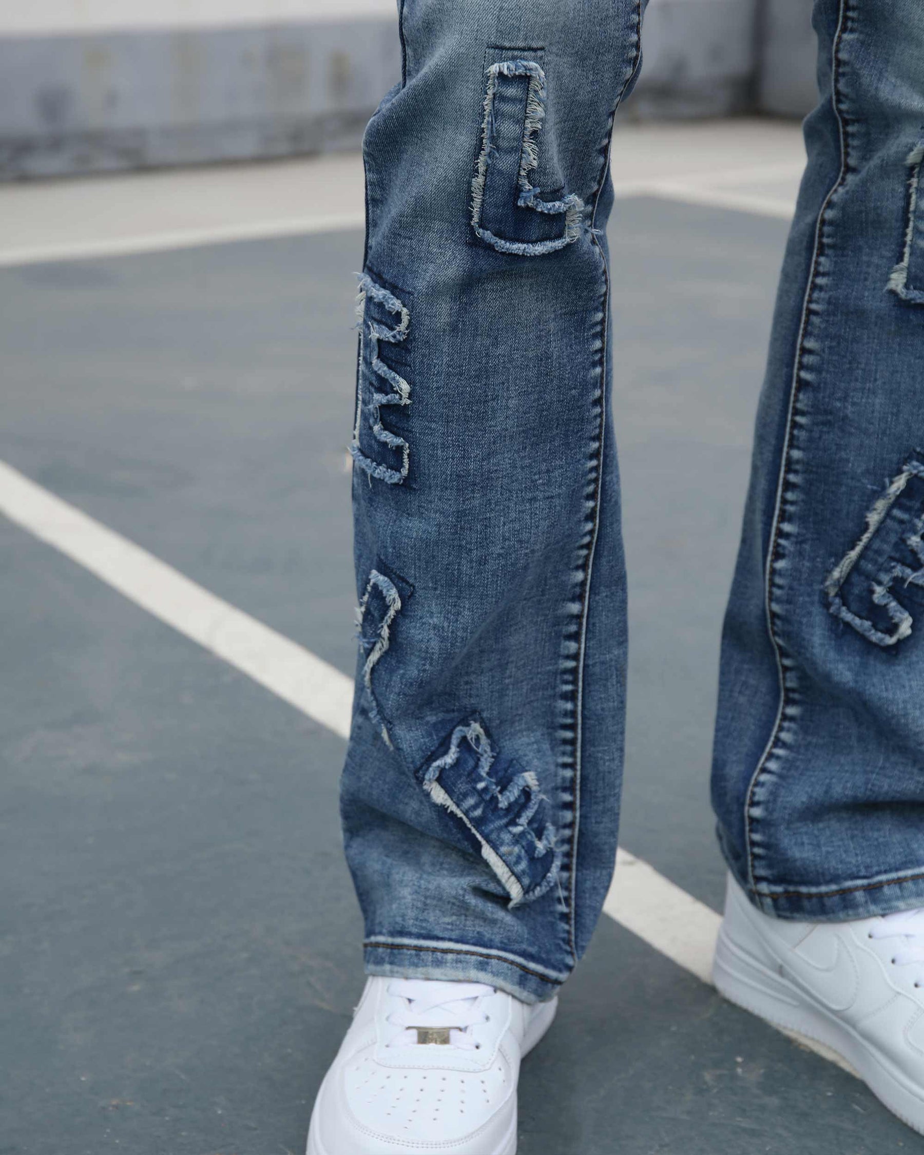 Light Wash Blue Jeans with Ripped Text