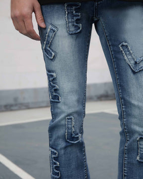 Light Wash Blue Jeans with Ripped Text