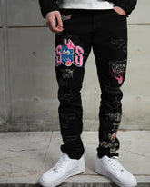 Vaqueros rasgados con patchwork de streetwear negros