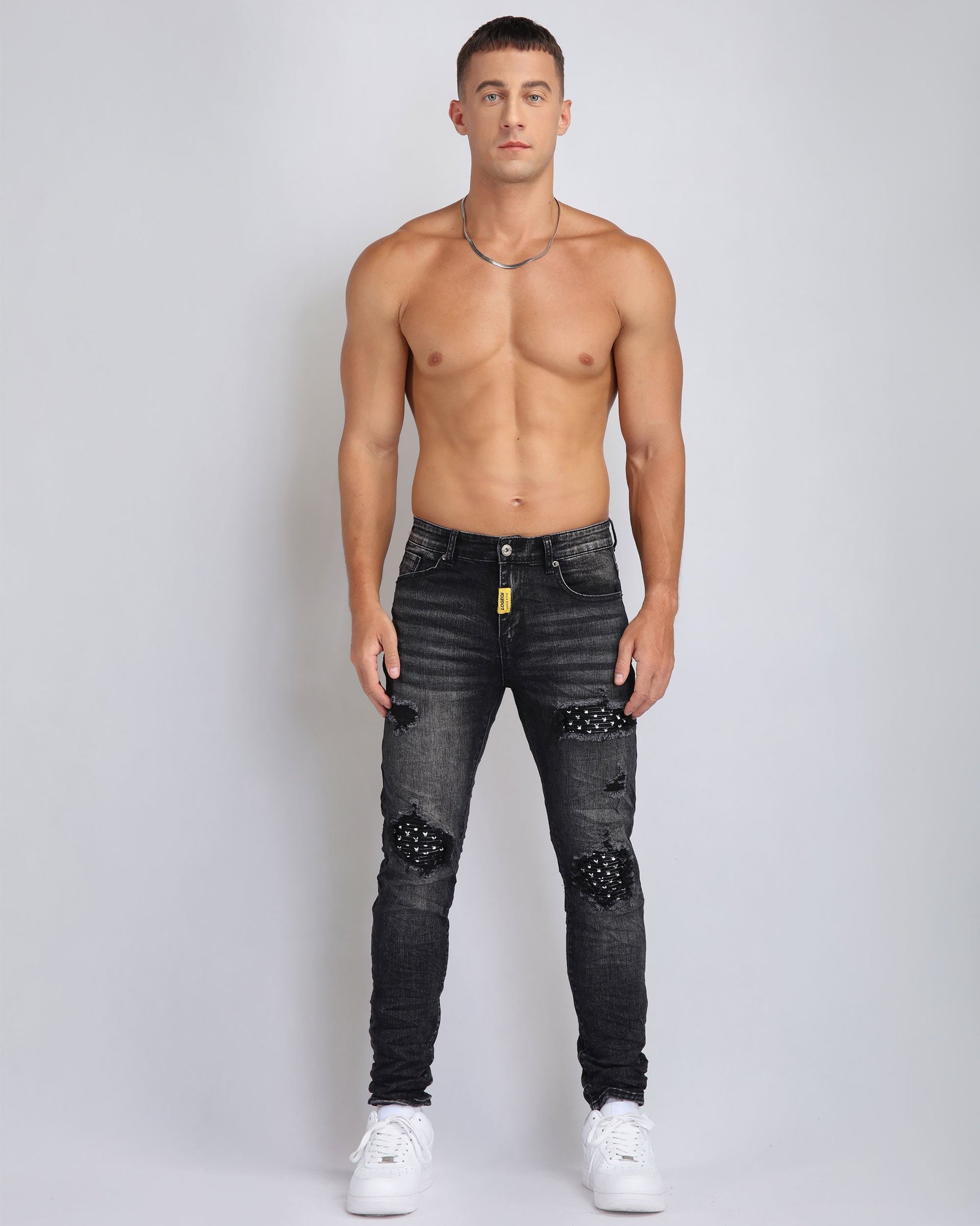 Black Ripped Jeans with Striking Black Patches