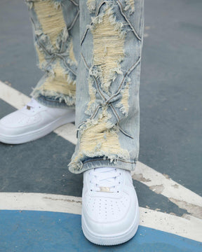 Flared Blue Jeans with Distressed and Large Ripped Detail