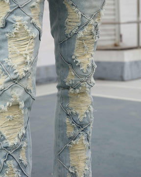 Flared Blue Jeans with Distressed and Large Ripped Detail